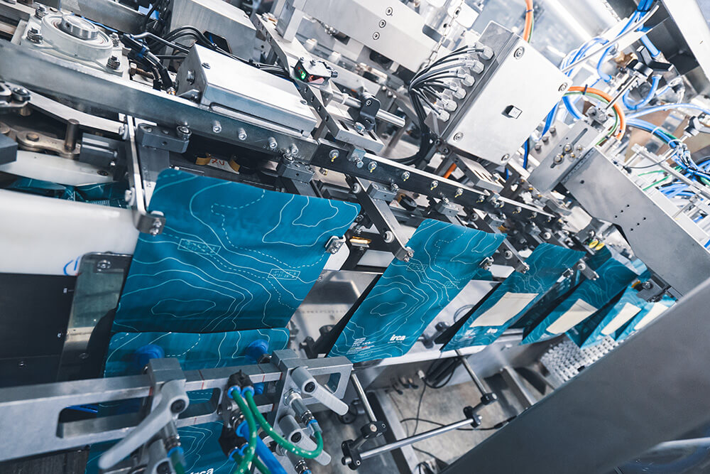 Dry pet food packages inside an automatic pouch filling machine